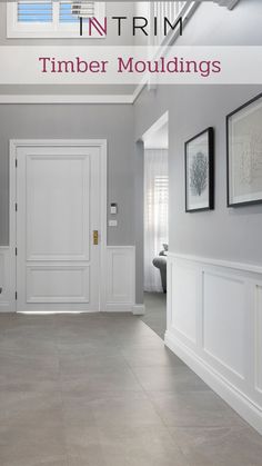 an empty hallway with white trim and moldings