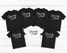 six black and white shirts with some sayings on the front, one says something to drink