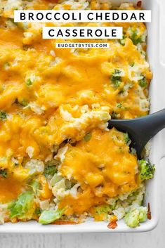 broccoli cheddar casserole in a white dish with a black spoon