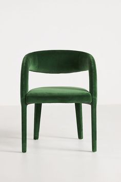 a green chair sitting on top of a white floor