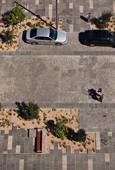 an overhead view of two cars parked on the street