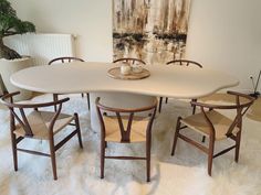 a white table with four chairs around it