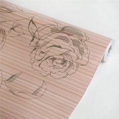 a roll of wood paper with a drawing of a flower on the front and side