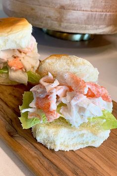 the sandwich is cut in half and ready to be eaten on the cutting board or serving platter