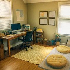 a home office with a desk, chair and ottoman in the middle of the room