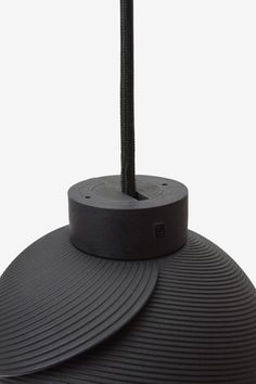 a black lamp that is on top of a table