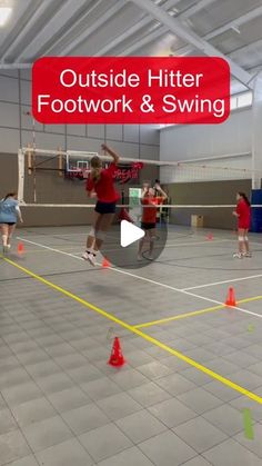 two people are playing tennis in an indoor court with orange cones on the floor and one person is jumping up to hit the ball