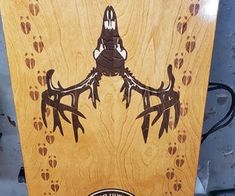 a wooden board with an image of a bird on it's back and the words,