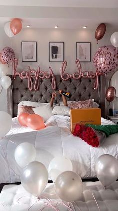 a bedroom decorated with balloons and streamers for a bridally glamp party