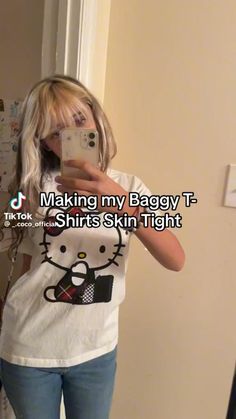 a woman taking a selfie in front of a mirror with the caption making my baggy t - shirt shirts skin tight