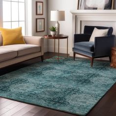 a living room filled with furniture and a rug on top of a hard wood floor