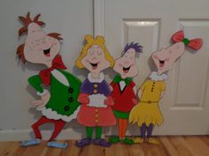 three cartoon characters standing in front of a door