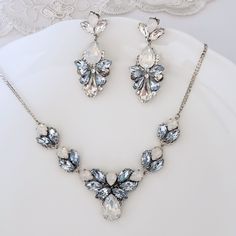 Elegant Vintage style Bridal Necklace. Made with high-quality Swarovski crystals in light blue and white opal, finished with a delicate silver chain. All designed and made by me in my SimplyChic studio. The length of the necklace is 16inches plus a 2-inch extension chain for flexible length. Matching earrings at this link: https://www.etsy.com/listing/718592806/sapphire-light-blue-statement-earrings?ref=shop_home_active_118&pro=1&frs=1 https://www.etsy.com/listing/797029875/sapphire-ligh Dusty Blue Necklace, Light Blue Crystal Jewelry For Wedding, Light Blue Crystal Wedding Jewelry, Blue Crystal Jewelry Sets For Wedding, Elegant Light Blue Necklace For Wedding, Elegant Light Blue Wedding Necklaces, Blue Sparkling Stone Necklaces For Wedding, Blue Necklaces With Sparkling Stones For Wedding, Blue Sparkling Stones Necklace For Wedding