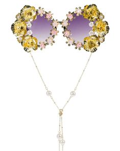 These dramatic gold floral Funglasses will make you feel ultra fabulous- the compliments are guaranteed OFF THE CHARTS! These plastic frames have round shaped dark tinted lenses and feature an all-over hand embellished frame with assorted flower accents. Each pair is one-of-a-kind and as unique as you are. As if it couldn't get anymore fabulous, these Funnies are complete with a removable neck chain strap with pearl embellishment attached at each temple! **Attention Fabulous Queen! Our Funglasse Gold Metal Sunglasses For Party, Glamorous Gold Party Sunglasses, Glamorous Gold Sunglasses For Party, Glamorous Gold Sunglasses For Summer, Gold Party Sunglasses With Adjustable Fit, Summer Party Glass Jewelry, Adjustable Metal Sunglasses For Party, Elegant Gold Sunglasses, Elegant Gold Sunglasses For Spring