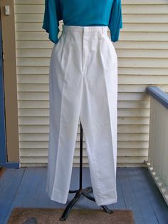 "Pleated-front trousers were popular during the 1980s. As you can see in the 2nd picture, the trousers have 4 - 6 pleats in the front for a very loose and flowy fit. The waist is at the natural waist above the hips. The tight waistline and flowy trousers make the waist seem smaller. The looseness of the trousers covers any lumps and bumps. These trousers pair well with the flowy 1980s tops. Check those out in this store. These 1980s vintage trousers are made of White Cotton/Polyester Twill fabri Classic Pleated Bottoms For Daywear, Vintage Summer Pants With Belt Loops, High Waist Pleated Bottoms For Daywear, Vintage Spring Workwear Bottoms, Vintage High-waisted Pants For Spring, Vintage Wide Leg Pants With Elastic Waistband, Vintage Fitted Bottoms With Elastic Waistband, Retro Spring Daywear Bottoms, Vintage Loose Fit Wide Leg Pants