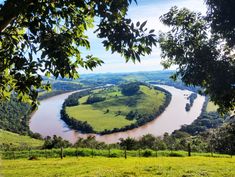 a river running through a lush green countryside