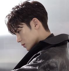 a young man wearing a black leather jacket