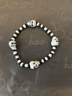 This is a Skull Halloween bracelet. It would make a spooky addition to a little boys Halloween costume. It would make a great gift for a little boy for Halloween. They make great Halloween party favors. It has four white skull beads. It has white and black seed beads. It was made with .8mm sturdy stretch string. I tie it several times to prevent breakage. It fits boys ages 4-8. It stretches to fit on the wrist. All items are ready to be shipped I do combined shipping. Items ship in 2-5 business Halloween Beaded Necklace, Bracelets For Boys, Boys Halloween Costume, Halloween Beaded Jewelry, Bracelets For Kids, Patriotic Bracelet, Skull Beads, Halloween Bracelet