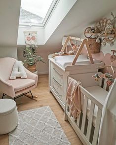 a baby's room with a pink chair and white crib