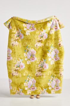 a yellow skirt with pink flowers on it