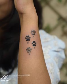 a person with a dog paw tattoo on their arm