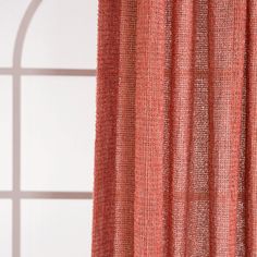 an orange curtain hanging in front of a window