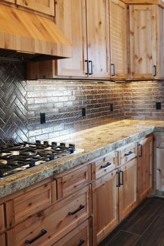 a kitchen with wooden cabinets and tile backsplashes on the counter top,