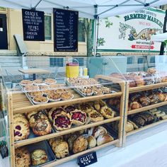 an assortment of baked goods on display under a tent