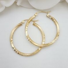 Beautiful Real 14k Gold Twisted 2 textures diamond cut hoop earrings. Perfect for everyday and special occasions. Unique, modern and everlasting. Ideal gift for her. 14k Gold will not tarnish or rust. Material: 14k Yellow Gold Diameter: 30mm Thickness: 2.5mm Weight: 2.2 grams 14k Gold stamped Gift Box Included Brand new Briza Collections is a small family owned business that works hard on providing the best selection of Fine Solid Gold Jewelry for the best prices.  Our Goal is to bring you happi Solid Gold Jewelry, Jewelry Unique, Small Family, Jewelry Earrings Hoops, Diamond Cut, Ideal Gift, Solid Gold, Diamond Cuts, Gold Jewelry