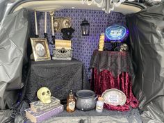 the trunk of a car is filled with halloween decorations and other things to decorate it