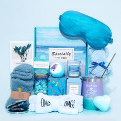 a gift hamper filled with personal care items, such as eye masks and towels