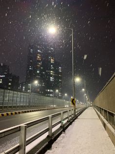 a snowy night in the city with street lights