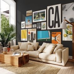 a living room filled with furniture and lots of framed pictures on the wall above it