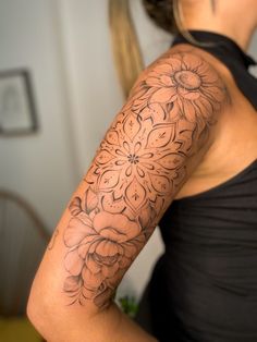 a woman with a flower tattoo on her arm