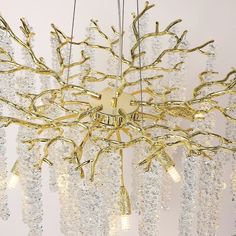 a chandelier with many lights hanging from it's sides and branches in the middle