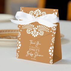 a small brown and white gift bag on a table