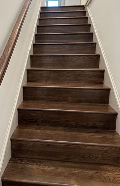 a set of wooden stairs leading up to a window