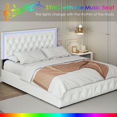 a white bed sitting on top of a wooden floor next to a rainbow colored wall