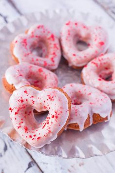 donuts with white frosting and red sprinkles