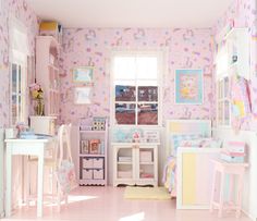 a doll house bedroom with pink walls and pastel furniture, including desks and chairs