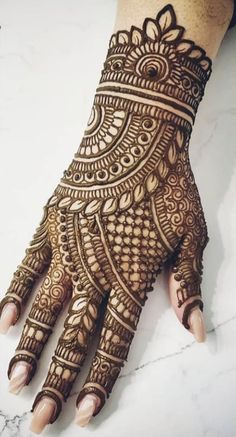 henna tattoo on the palm of someone's hand