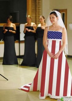 a woman in an american flag dress standing on the floor with other women behind her