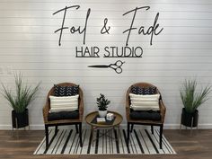 two chairs sitting next to each other in front of a sign that says foot & fab hair studio