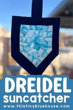 the dreidel suncather is hanging from a window with text overlay