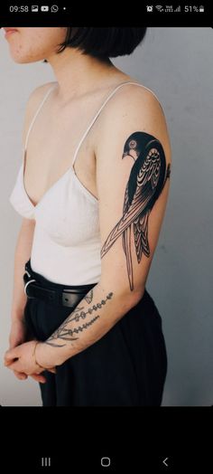 a woman with a bird tattoo on her arm