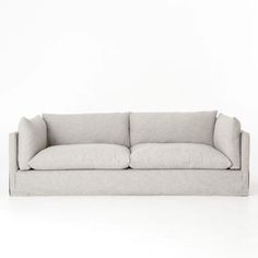 a white couch with two pillows on it