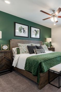 a bedroom with green walls and white bedding