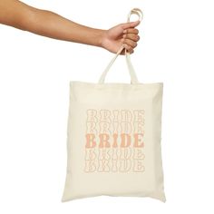 a person holding a bag with the words bride and bridal on it's side