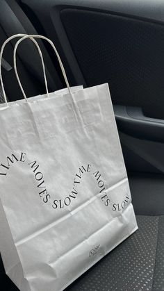 a white paper bag sitting in the back seat of a car