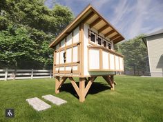 a small wooden structure sitting on top of a lush green field